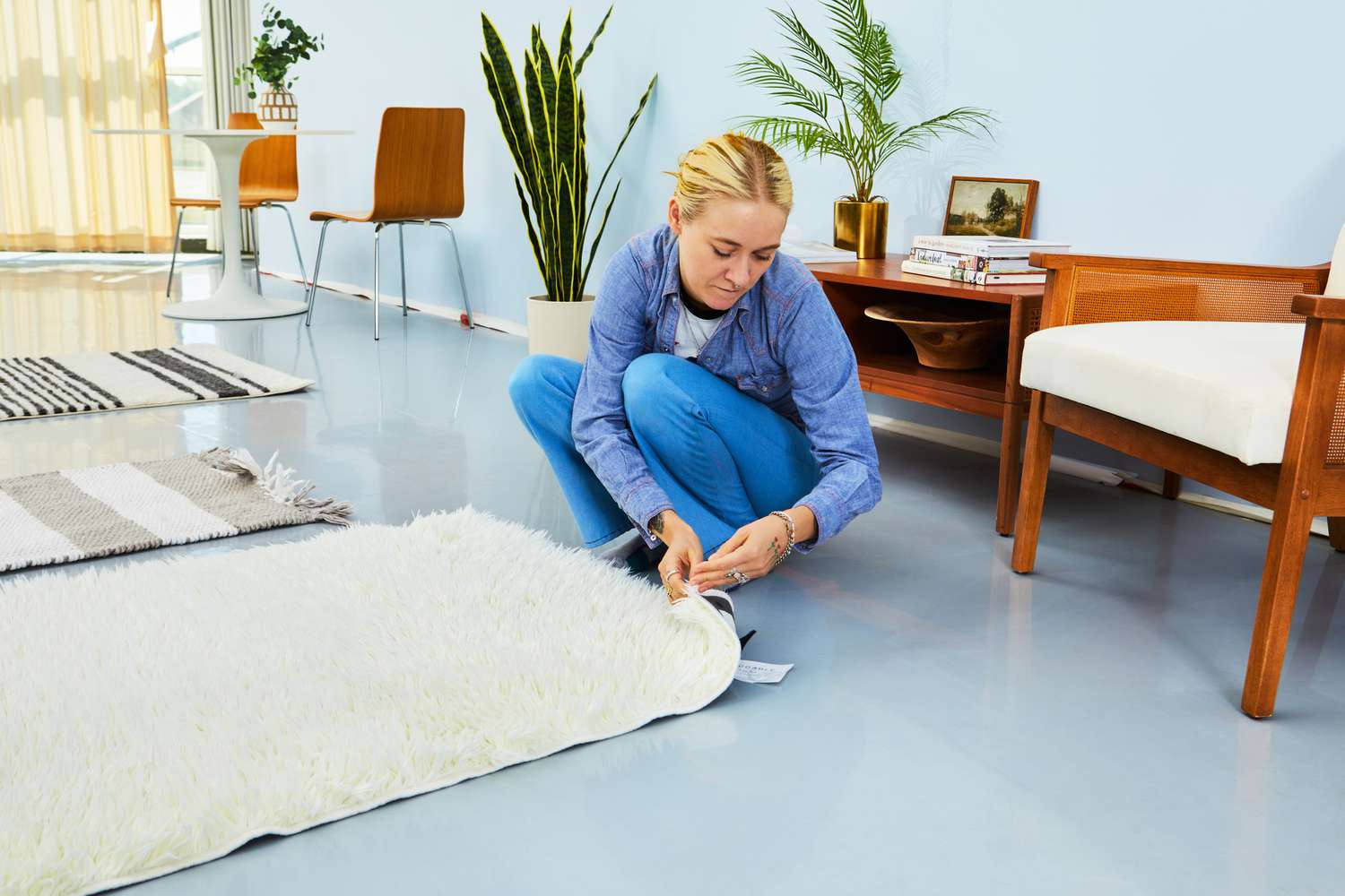 A person lifting up one of the corners of the Ruggable Shag Rug