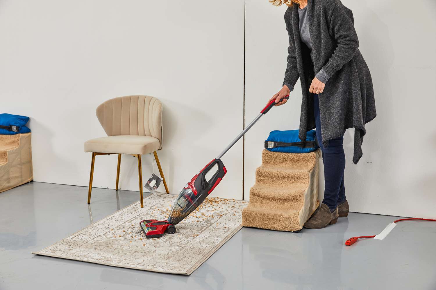 Person using DirtDevil Versa Cordless 3-in-1 Stick Vacuum to clean carpet