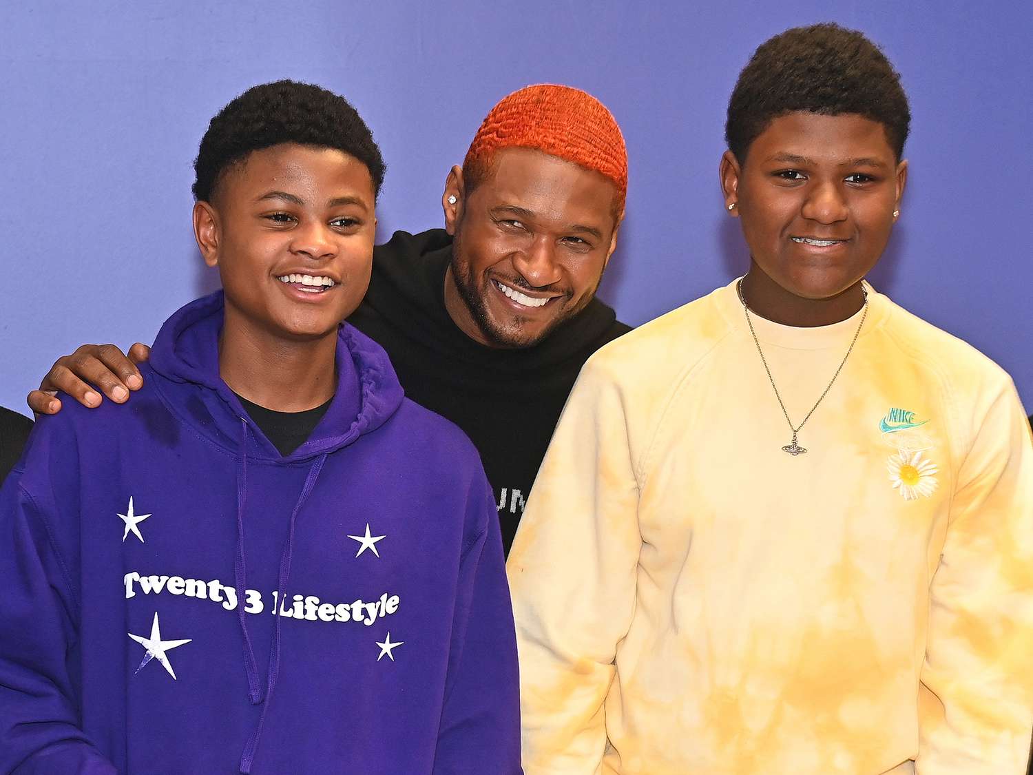 Usher Raymond (C) and his sons Usher "Cinco" Raymond V (L) and Naviyd Raymond (R) attend the Healthy Thanksgiving meals giveaway event on November 23, 2022