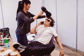 Harry Styles getting his hair styled
