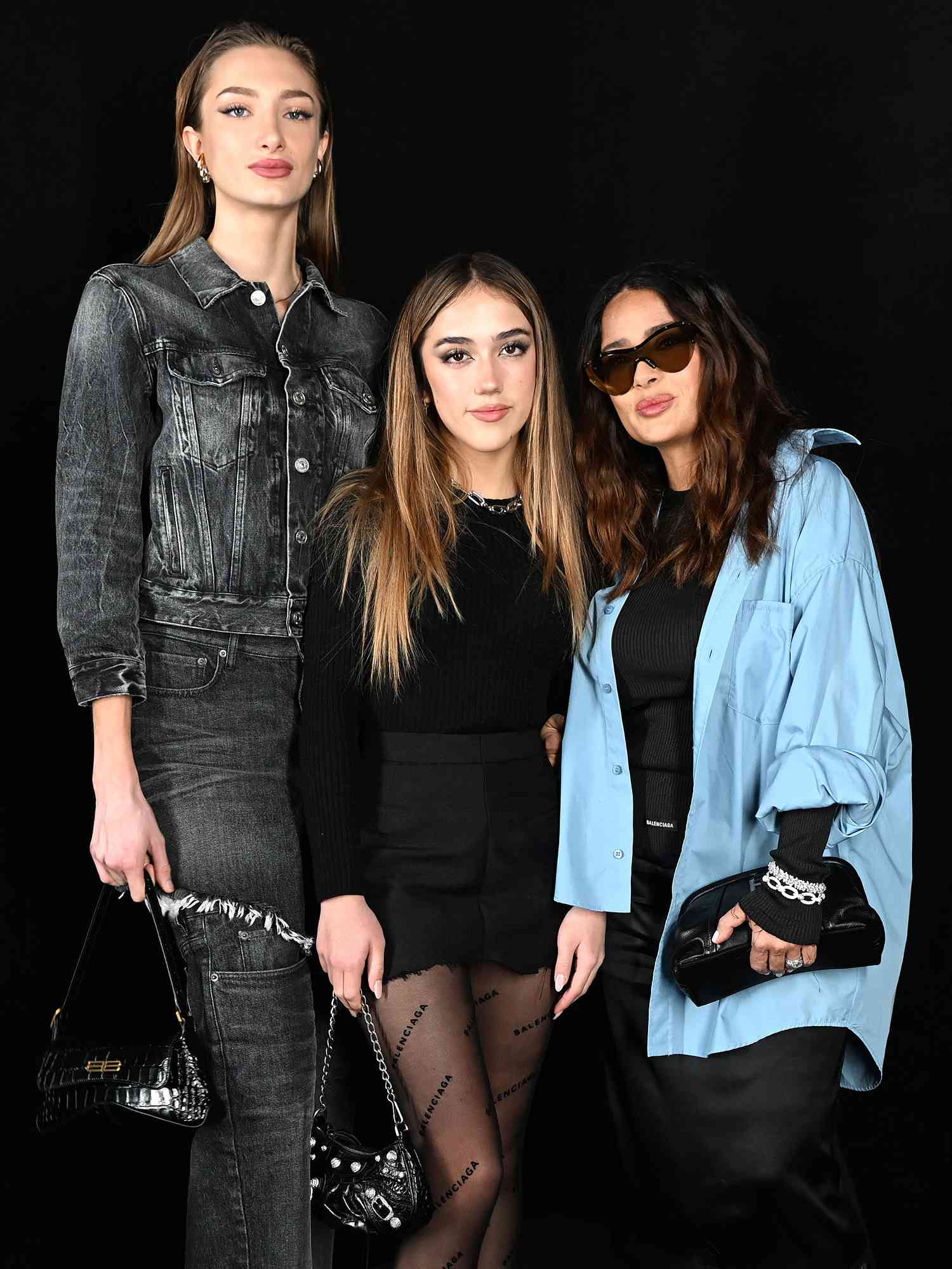 Mathilde Pinault, Valentina Paloma Pinault, and Salma Hayek attend the Balenciaga FW 22 show on March 06, 2022 in Le Bourget, France. 