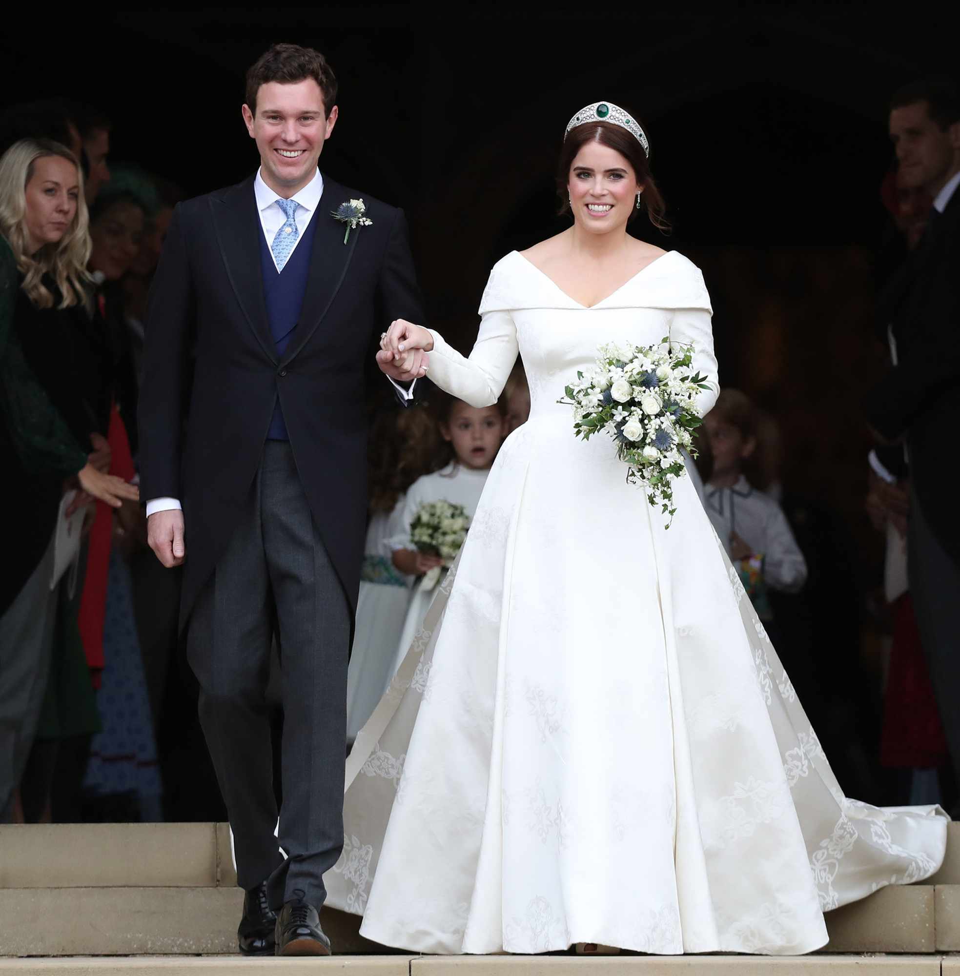 Princess Eugenie of York and her husband Jack Brooksbank on the steps of St George's Chapel after their wedding at St. George's Chapel on October 12, 2018 in Windsor, England