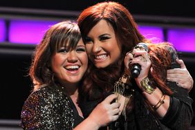 Kelly Clarkson and Demi Lovato perform during Z100's Jingle Ball 2011