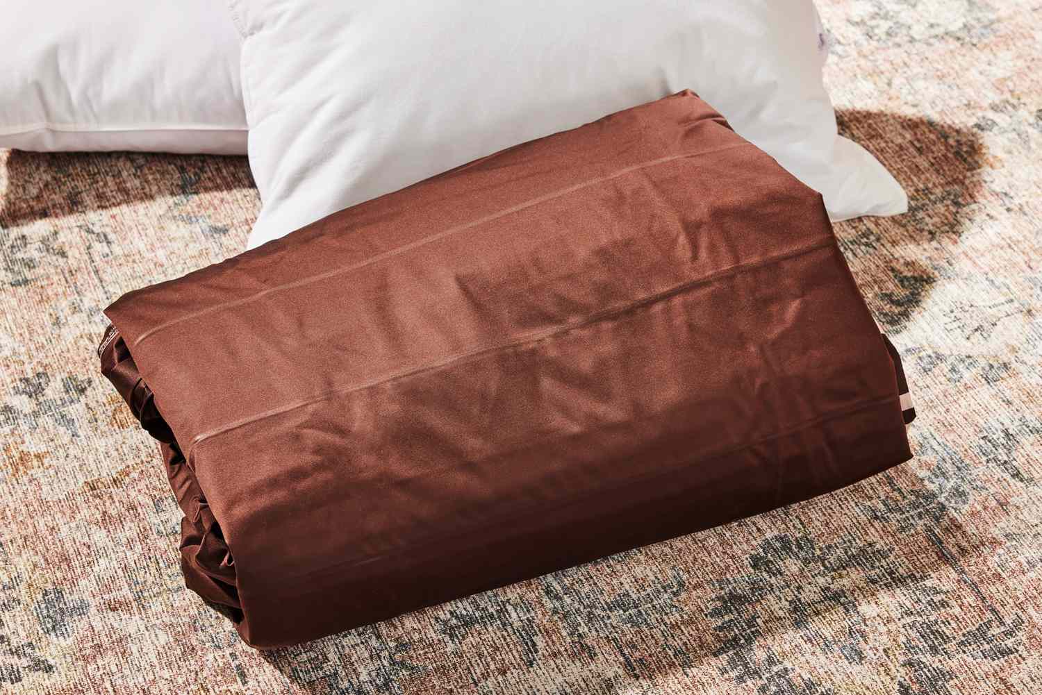 The Englander Air Mattress folded up on a rug