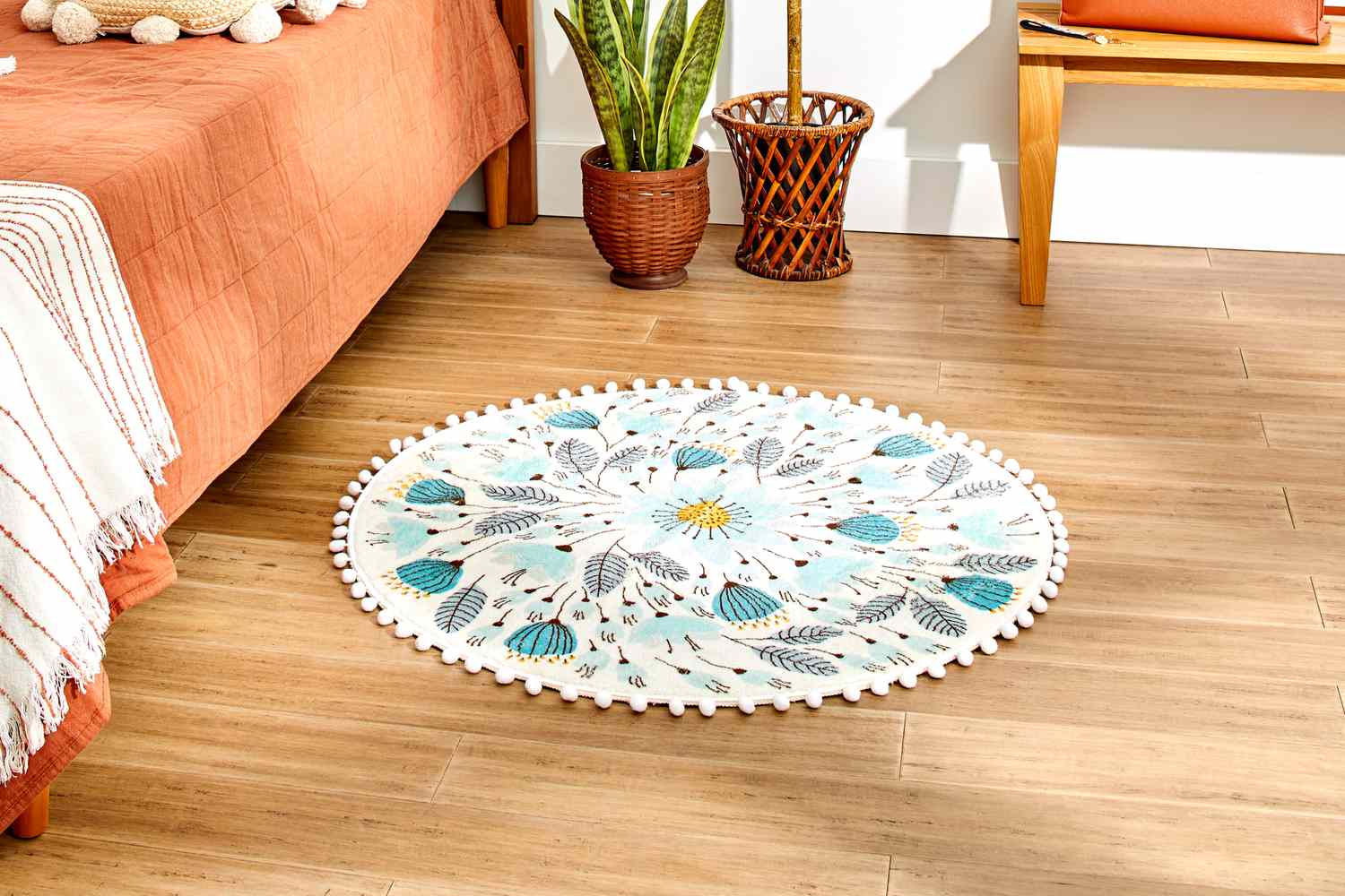 The Uphome Pom Pom Round Floral Rug in a bedroom setting