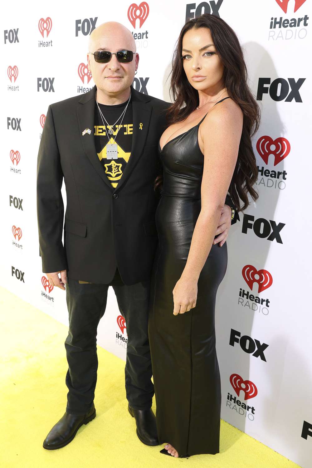 David Draiman of Disturbed and Sarah Uli attend the 2024 iHeartRadio Music Awards at Dolby Theatre in Los Angeles, California on April 01, 2024