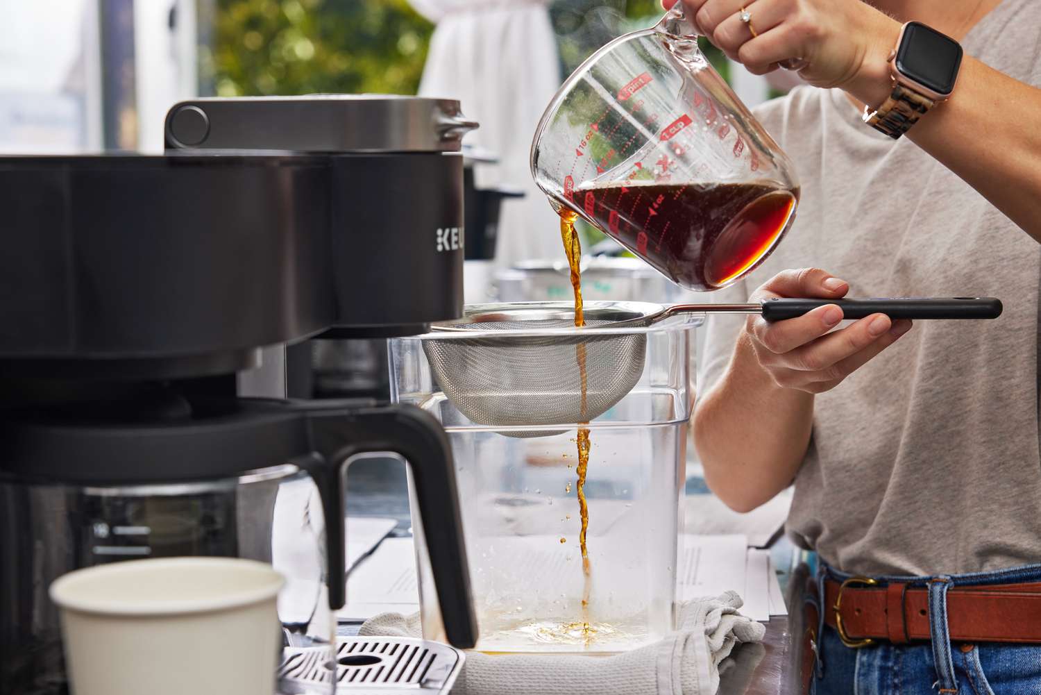 Person pouring coffee made with the Keurig K-Duo Coffee Maker during product testing