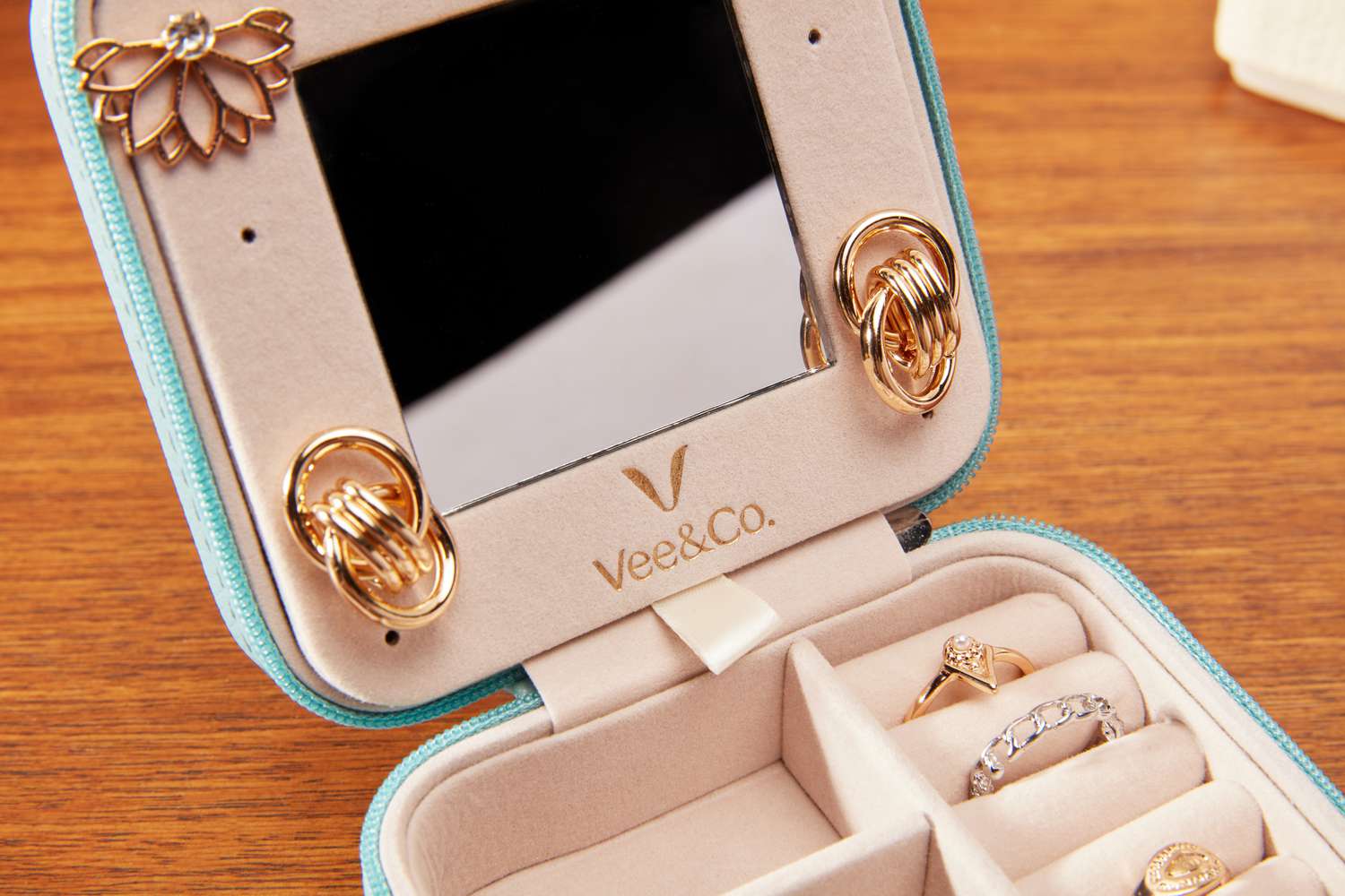 A close-up of the mirror and earring holders of the Vee & Co. Small Travel Jewelry Case.