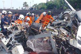 Emergency personnel work at the site of helicopter crash in Lumut, Perak, Malaysia 