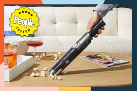  A person vacuuming popcorn with an Iris USA Handheld Vacuum