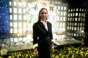 US actress Jennifer Lawrence poses in front of Dior's Christmas display "Carousel of Dreams" at Saks 5th Avenue department store in New York, November 20, 2023