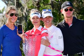 Nelly Korda of the United States poses with her family and the trophy following the final round of the Gainbridge LPGA at Lake Nona Golf and Country Club on February 28, 2021 