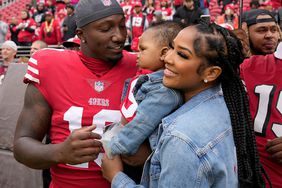 Deebo Samuel, Mahogany Jones, and Tyshun Raequan Samuel Jr. before an NFL football game between the 49ers and the Seattle Seahawks on September 18, 2022.