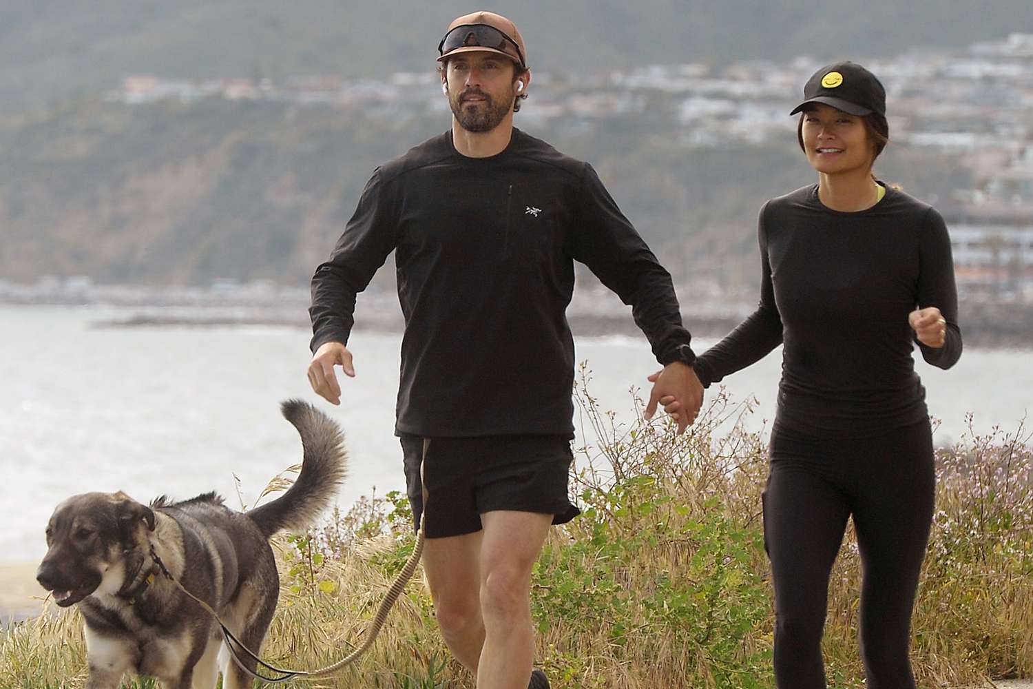 Milo Ventimiglia and wife Jarah Mariano hold hands on a jog in Los Angeles. The couple then sat on the tailgate of their truck as they took in the ocean view w