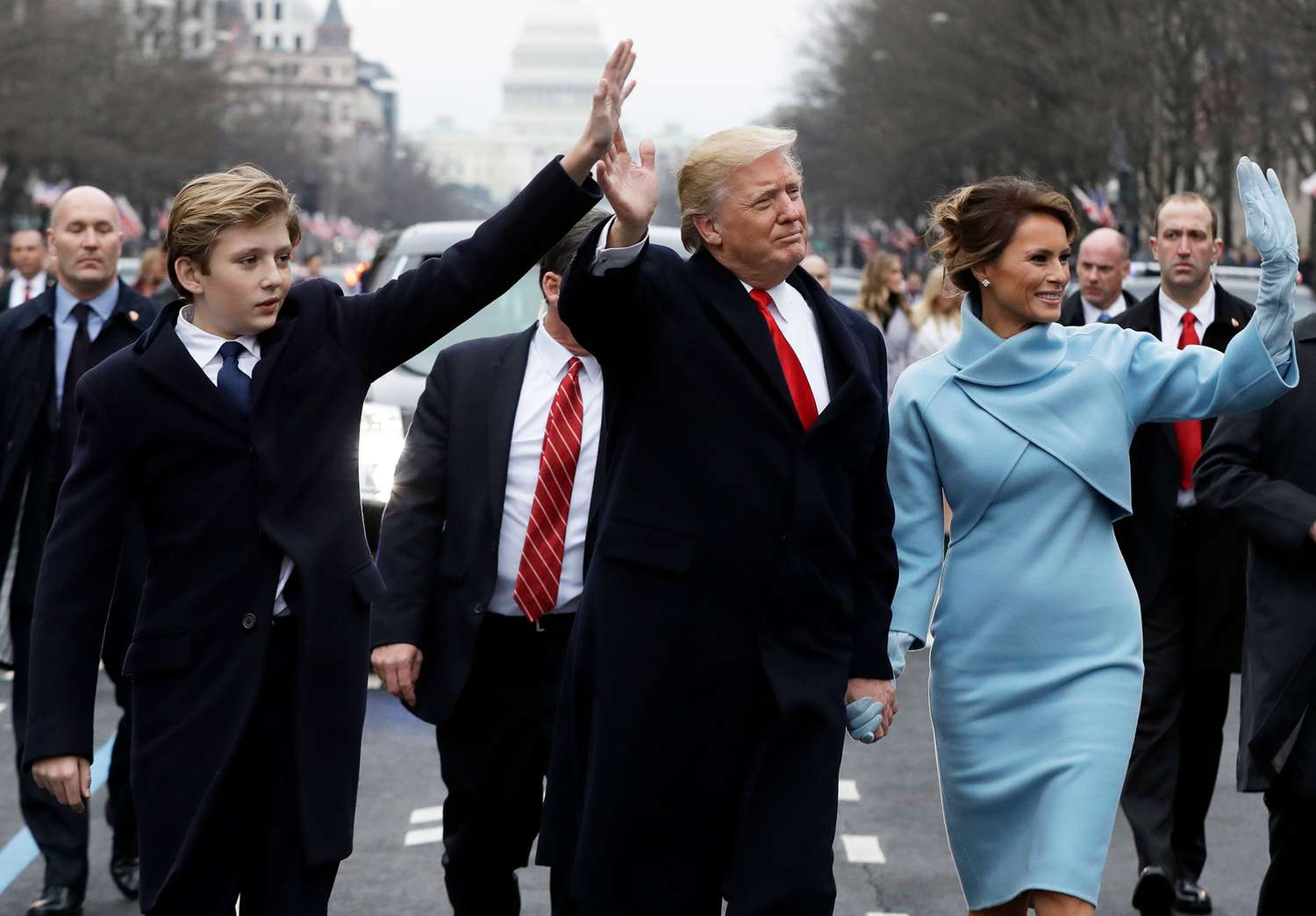 U.S. President Donald Trump waves to supporters as he walks the parade route with first lady Melania Trump and son Barron Trump after being sworn in at the 58th Presidential Inauguration 