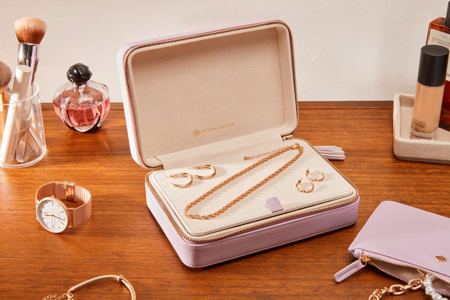 The Kendra Scott Medium Travel Jewelry Case filled with jewelry sitting on a table.