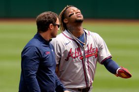 Atlanta Braves' Ronald Acuna Jr., right, walks off the field with a trainer after being injured while running the bases during the first inning of a baseball game against the Pittsburgh Pirates in Pittsburgh,