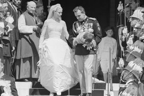 Grace Kelly and Prince Rainier of Monaco waving to the crowds from the Monaco Royal Palace after their wedding in the Cathedral of St. Nicholas.