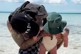 Travis Barker poses with son Rocky on the beach