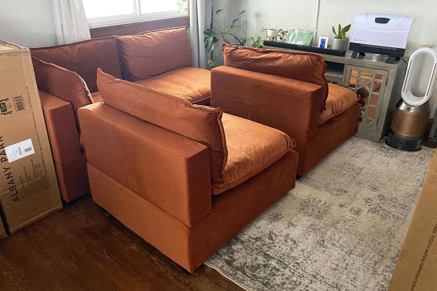 Four sections of the Albany Park Kova Pit Sofa displayed in a home