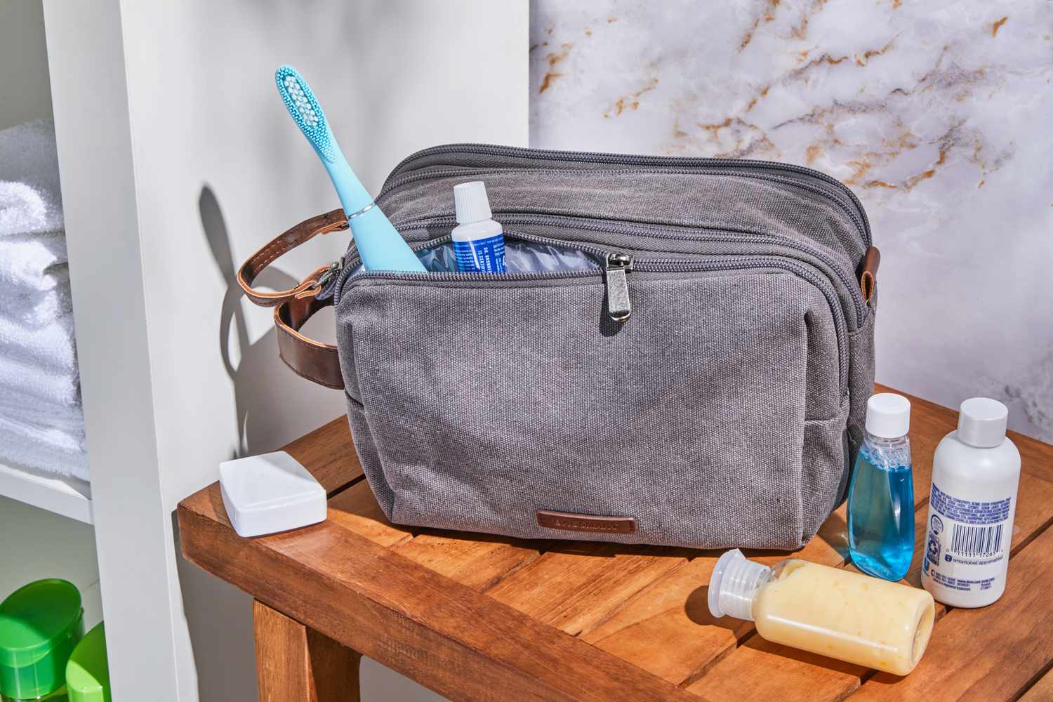 Bagsmart Toiletry Bag side compartment opened with a toothbrush and toothpaste sticking out