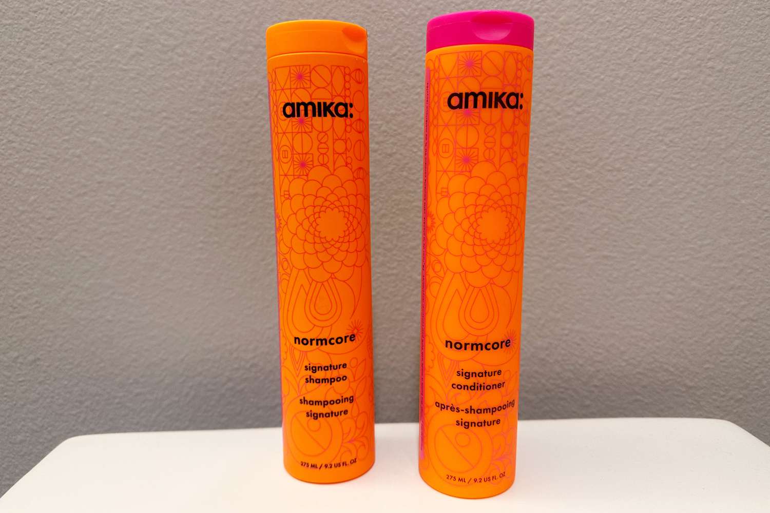 Two bottles of amika Normcore Hydrating Shampoo and Conditioner