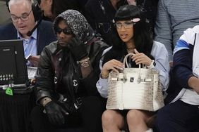 Cardi B, right, and her husband Offset watch the second half of Game 5 in an NBA basketball first-round playoff series between the New York Knicks and the Philadelphia 76ers