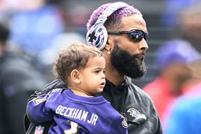 Odell Beckham Jr. #3 of the Baltimore Ravens carries his son before the game against the Detroit Lions at M&T Bank Stadium on October 22, 2023 in Baltimore, Maryland.