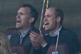 Prince William, Prince of Wales (R) reacts during the UEFA Europa Conference League semi final first leg football match between Aston Villa and Olympiakos 