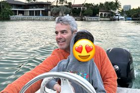 Andy Cohen and his son Ben drive the boat