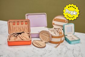 Five of the best travel jewelry cases on a marble table with a People tested badge.