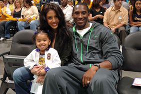 Kobe Bryant of the Los Angeles Lakers with his wife Vanessa and child Natalia watch the Los Angeles Sparks play the Sacramento Monarchs on August 16, 2005 