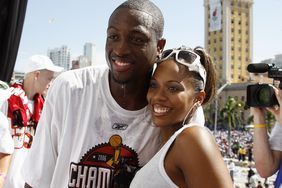 Dwyane Wade of the Miami Heat poses for a photo with wife Siohvaughn, during the Heats NBA championship victory parade at American Airlines Arena on June 23, 2006 in Miami, Florida