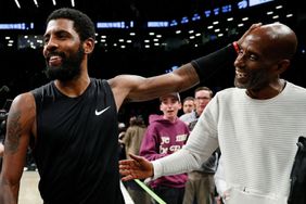 Kyrie Irving #11 of the Brooklyn Nets greets his father Drederick Irving after the second half against the Toronto Raptors at Barclays Center on October 21, 2022 in the Brooklyn borough of New York City