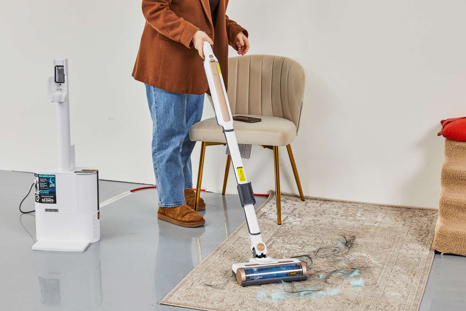 Women cleaning dust on the carpet using Shark WS642AE Wandvac Cordless Stick Vacuum with Self-Empty Charging Base