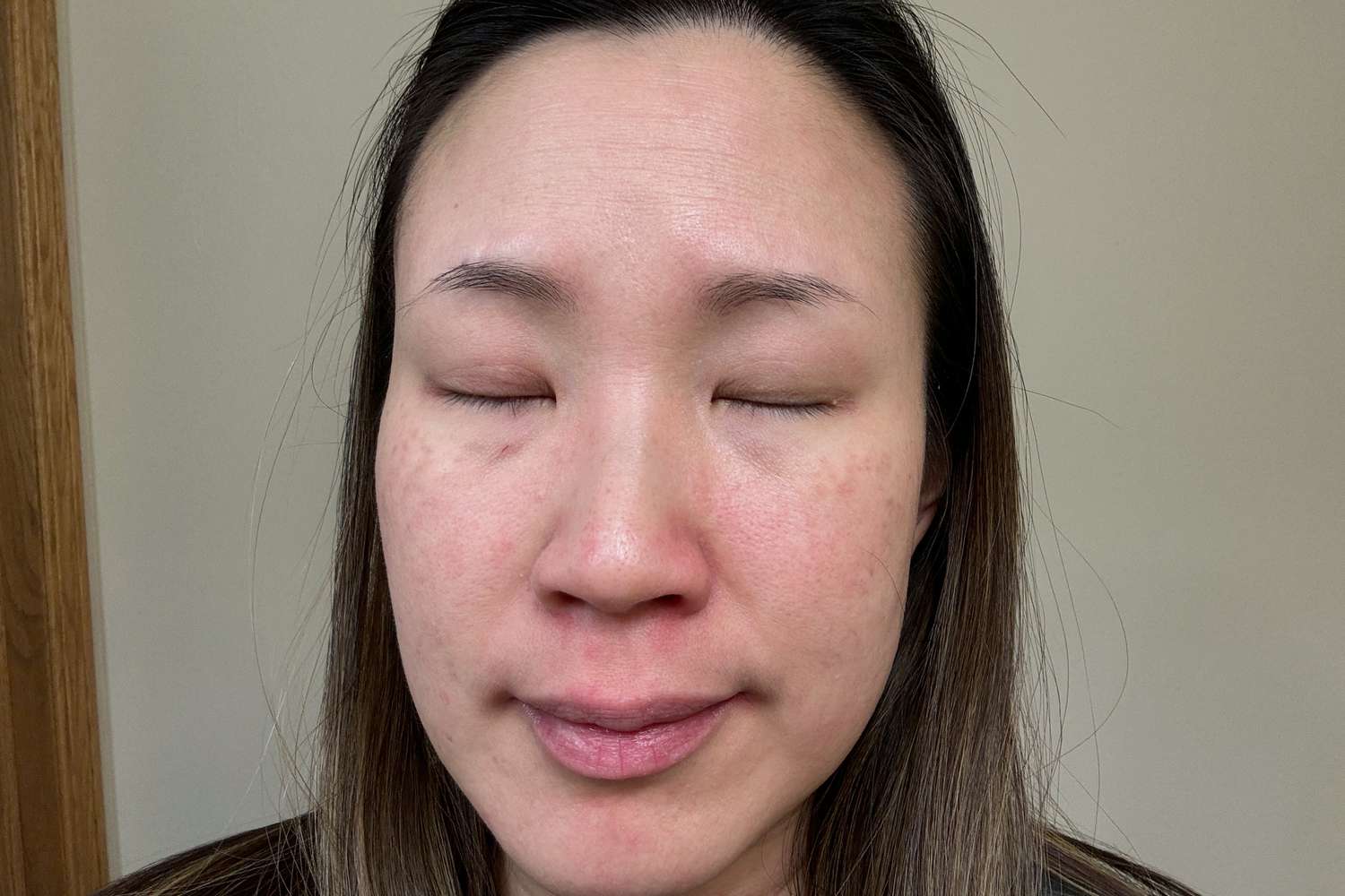 A person with eyes closed after using The Ordinary Multi-Peptide + Copper Peptides 1% Serum