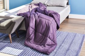 Purple Utopia Comforter spread across the bed and the floor 