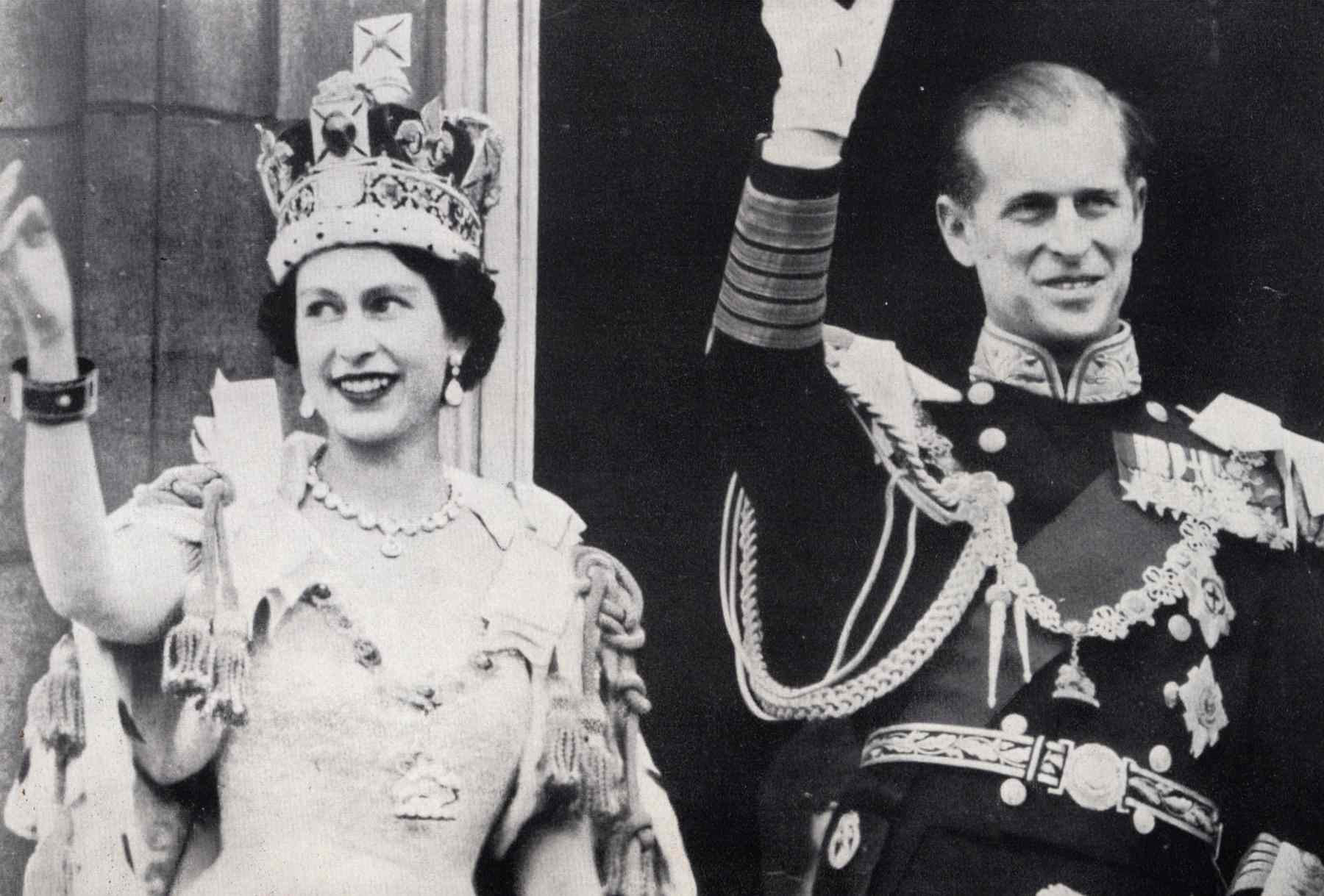 Queen Elizabeth II and Prince Phillip wave from Buckingham Palace.