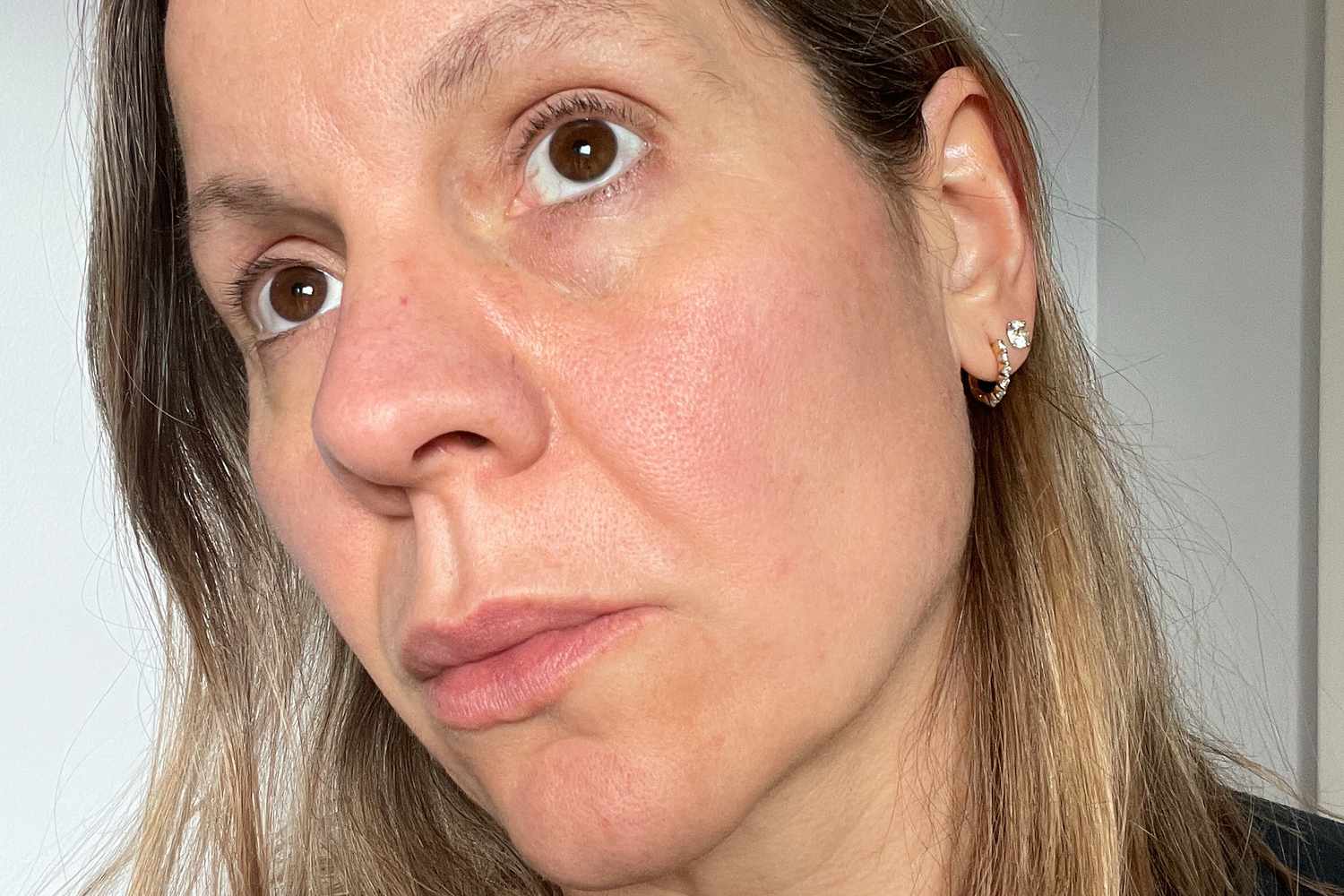 A person's face after using ISDIN ISDINCEUTICS Age Contour Firming and Rejuvenating Cream