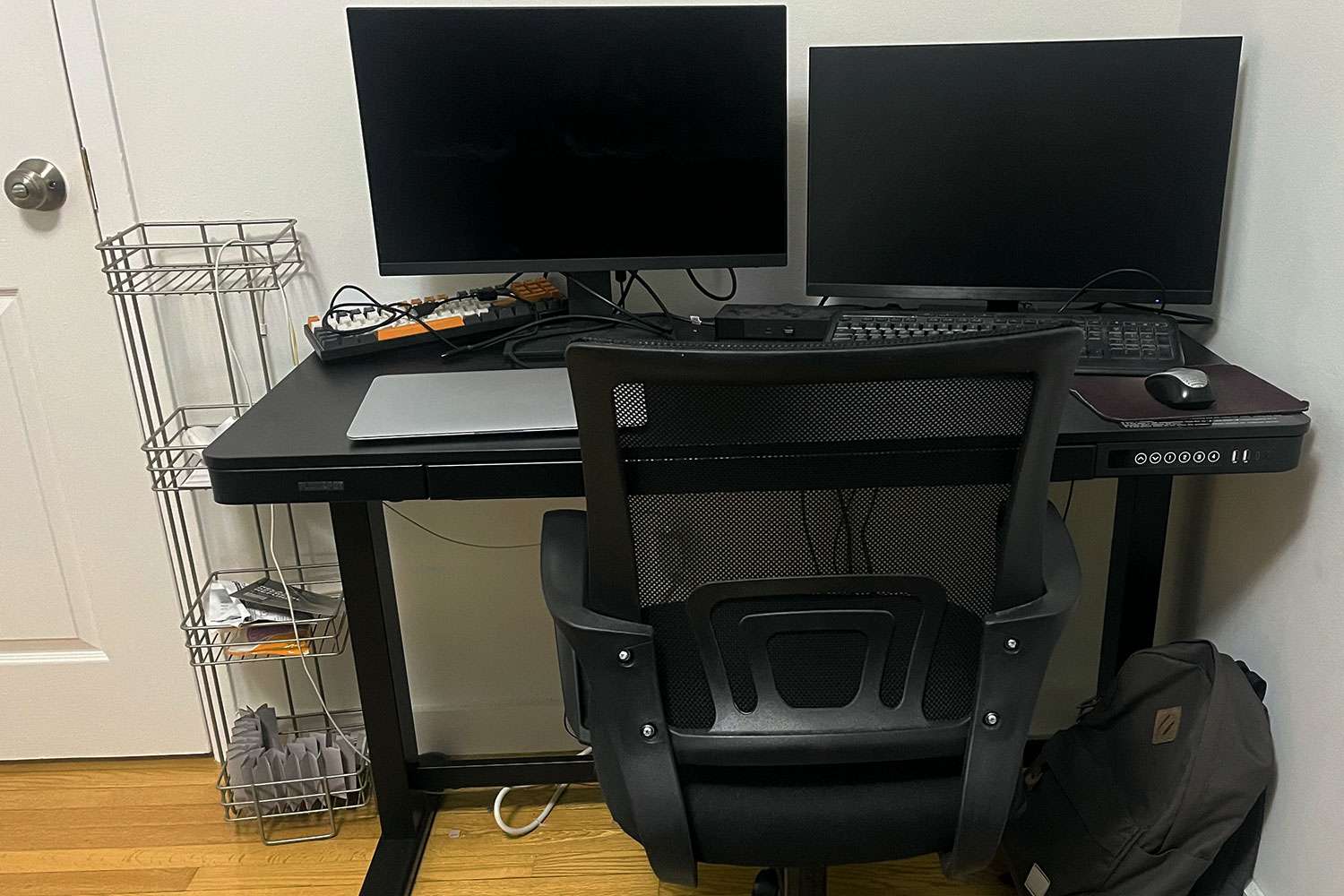 Flexispot EW8 Comhar Electric Standing Desk set up in a room with two monitors and a laptop