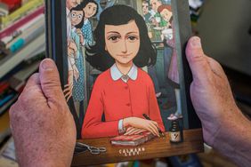  man holds a copy of the graphic novel version of "The Diary of Anne Frank", by Israeli writer-director Ari Folman and illustrator David Polonsky, in Paris on September 18, 2017.