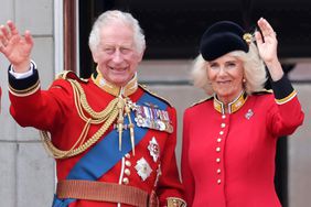 King Charles III and Queen Camilla wave as they watch the fly-past on the Buckingham Palace balcony during Trooping the Colour on June 17, 2023 in London, England.