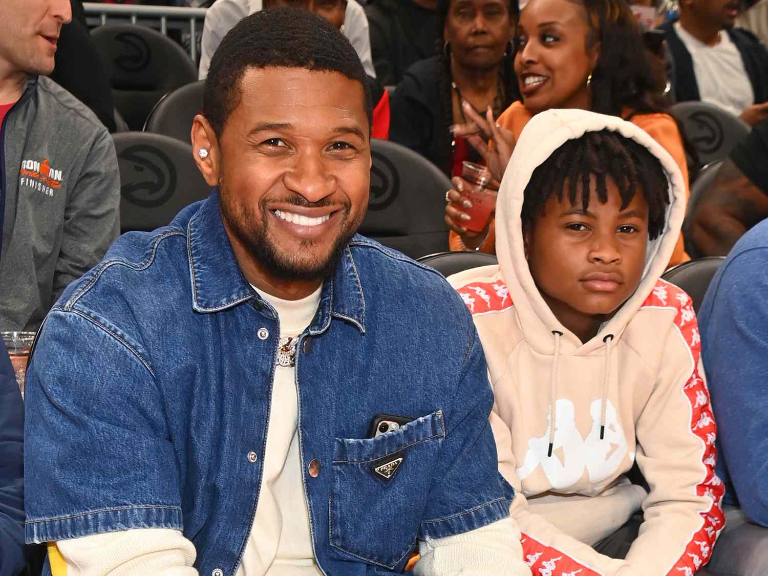 Usher Raymond and his son Usher Raymond V attend the game between Brooklyn Nets and the Atlanta Hawks at State Farm Arena on April 02, 2022 in Atlanta, Georgia
