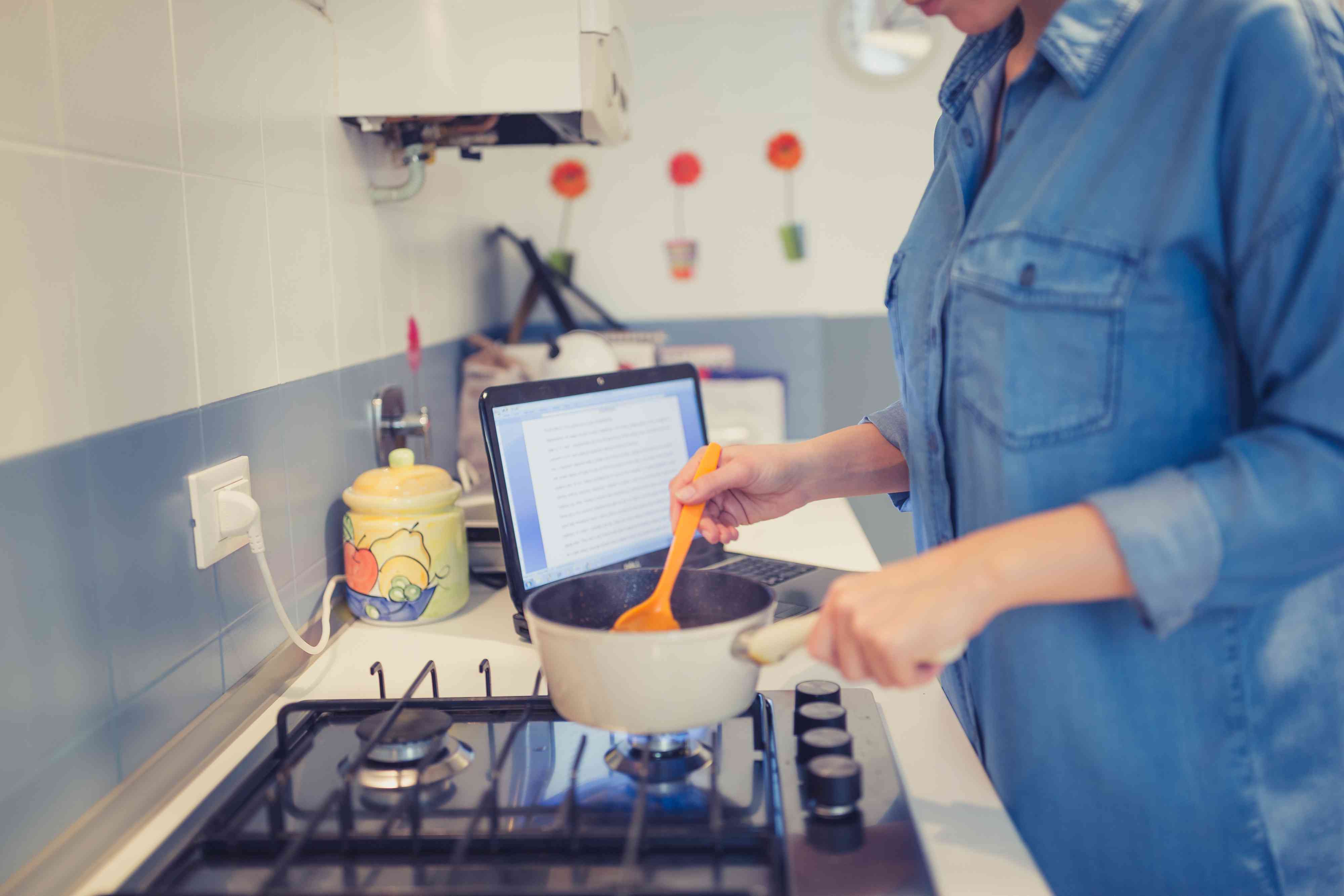 woman cooking while working stock image