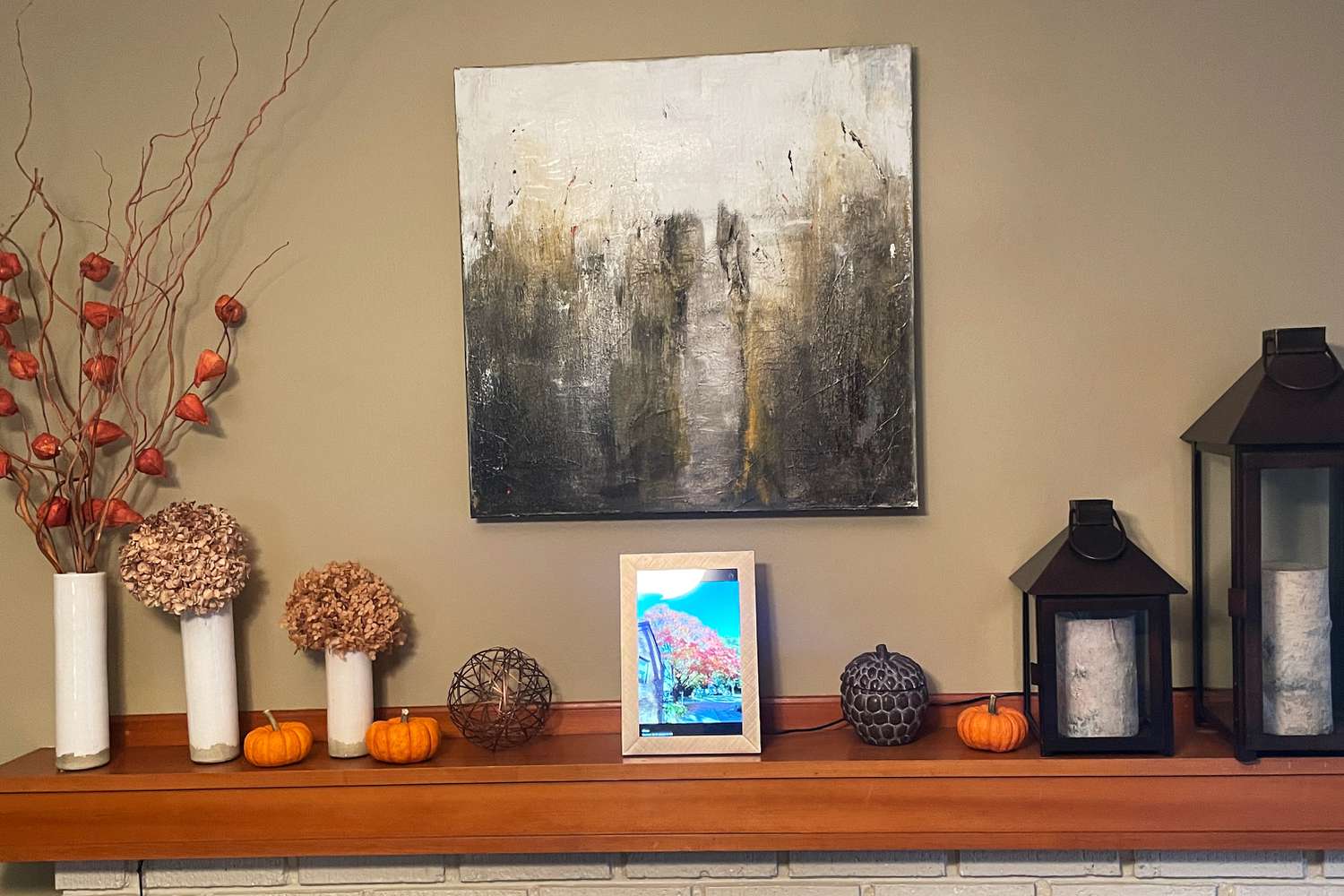Polaroid Digital Photo Frame on a ledge displaying the outdoors on a decorated fireplace mantel