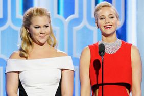 In this handout photo provided by NBCUniversal, Presenters Amy Schumer and Jennifer Lawrence speak onstage during the 73rd Annual Golden Globe Awards at The Beverly Hilton Hotel on January 10, 2016 in Beverly Hills, California.