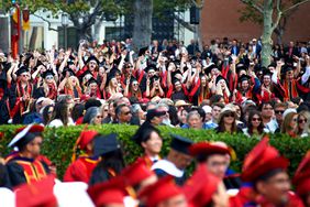 Graduates celebrate during the procession at University Of Southern California's 140th Commencement Ceremony at University of Southern California on May 12, 2023 in Los Angeles, California.