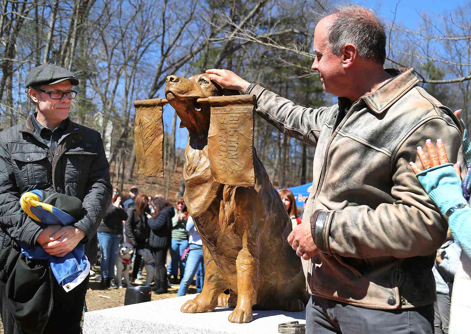 Ashland, MA - March 30: A statue was dedicated to honor Spencer, a Golden Retriever therapy dog who became the official dog of the Boston Marathon. Spencer from Holliston stood on the course in Ashland and held a Boston Strong flag in its mouth. The dog died from cancer on Feb. 17, 2023.
