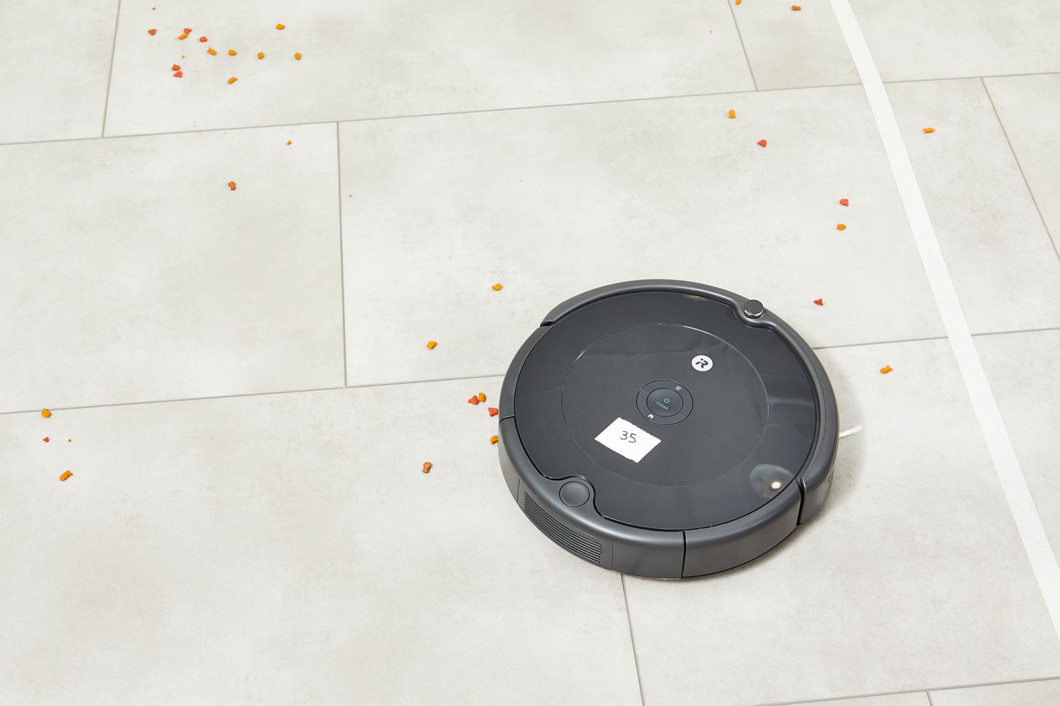 iRobot Roomba 694 Robot Vacuum cleaning food from tile floor