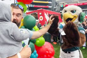 Jason Kelce with daughter Bennie meeting the Philadelphia Eagles mascot
